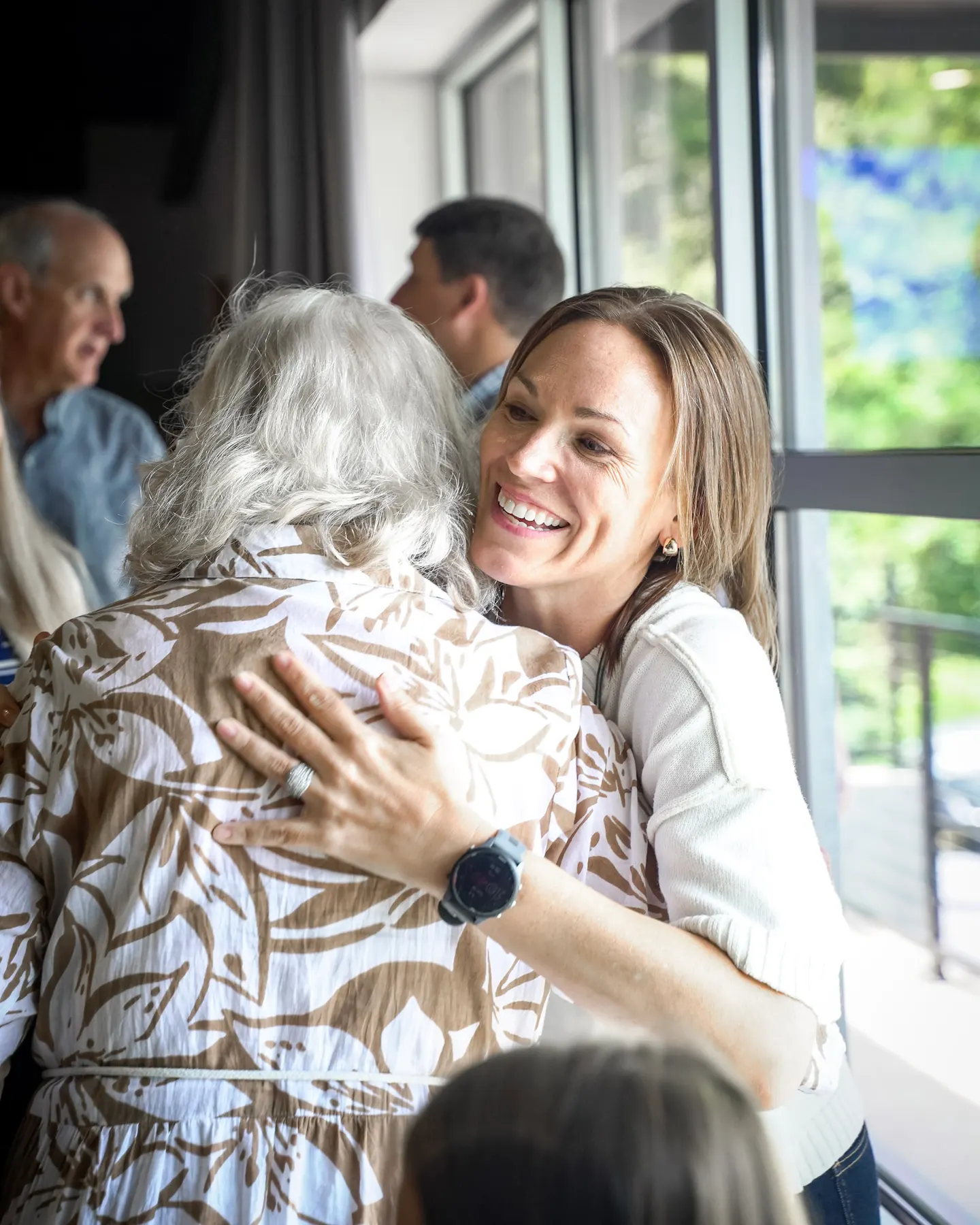 Two people embracing after a service