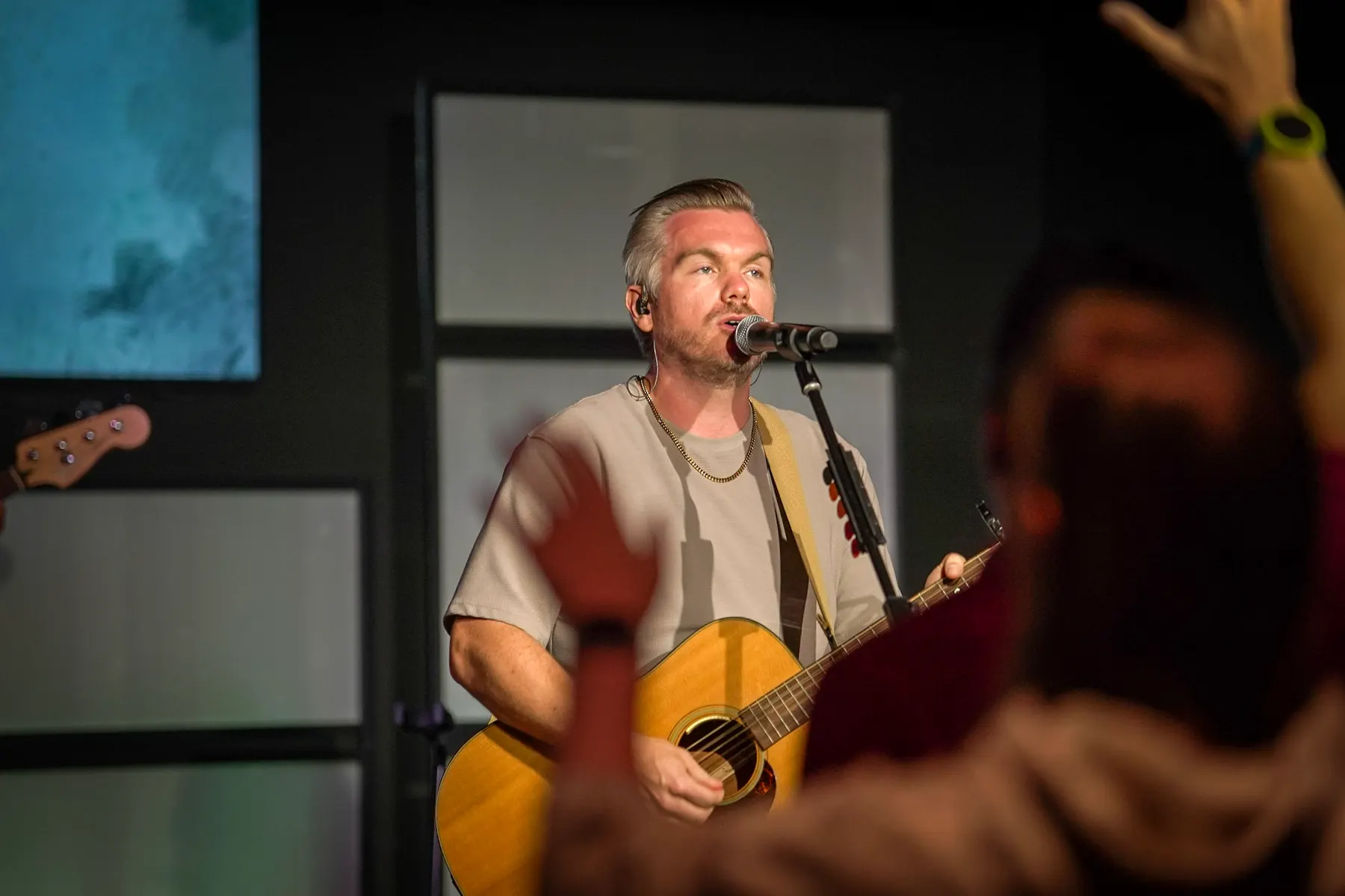A worship leader playing guitar