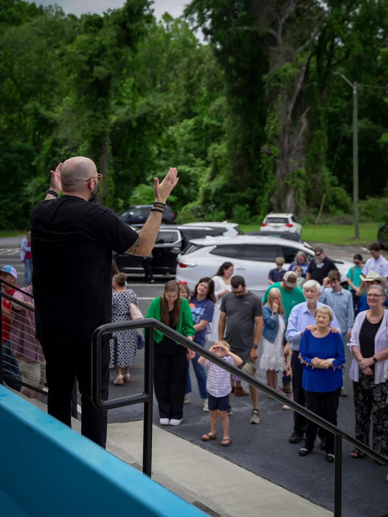 The church gathered round the tank on a baptism Sunday