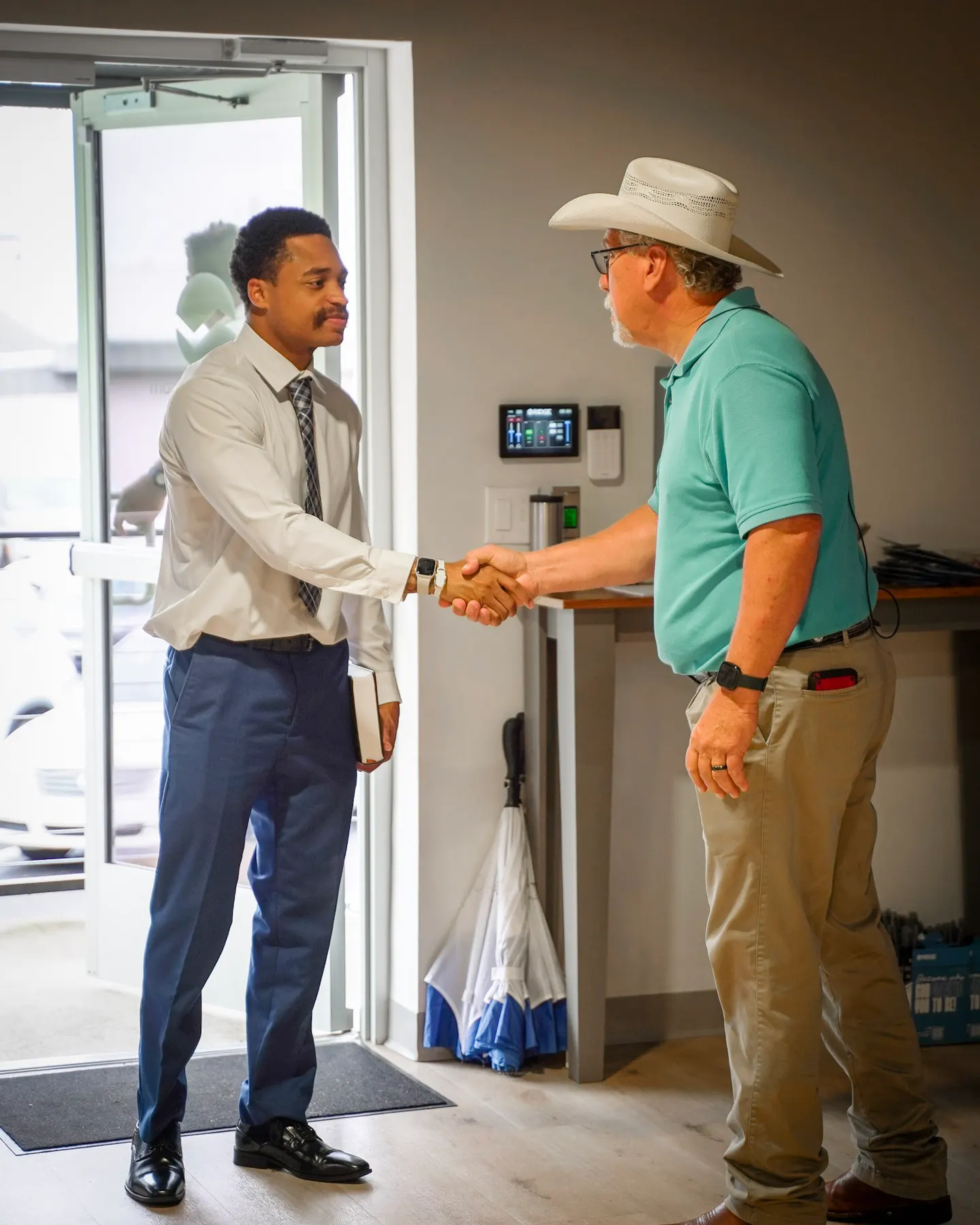 A handshake at the welcome desk