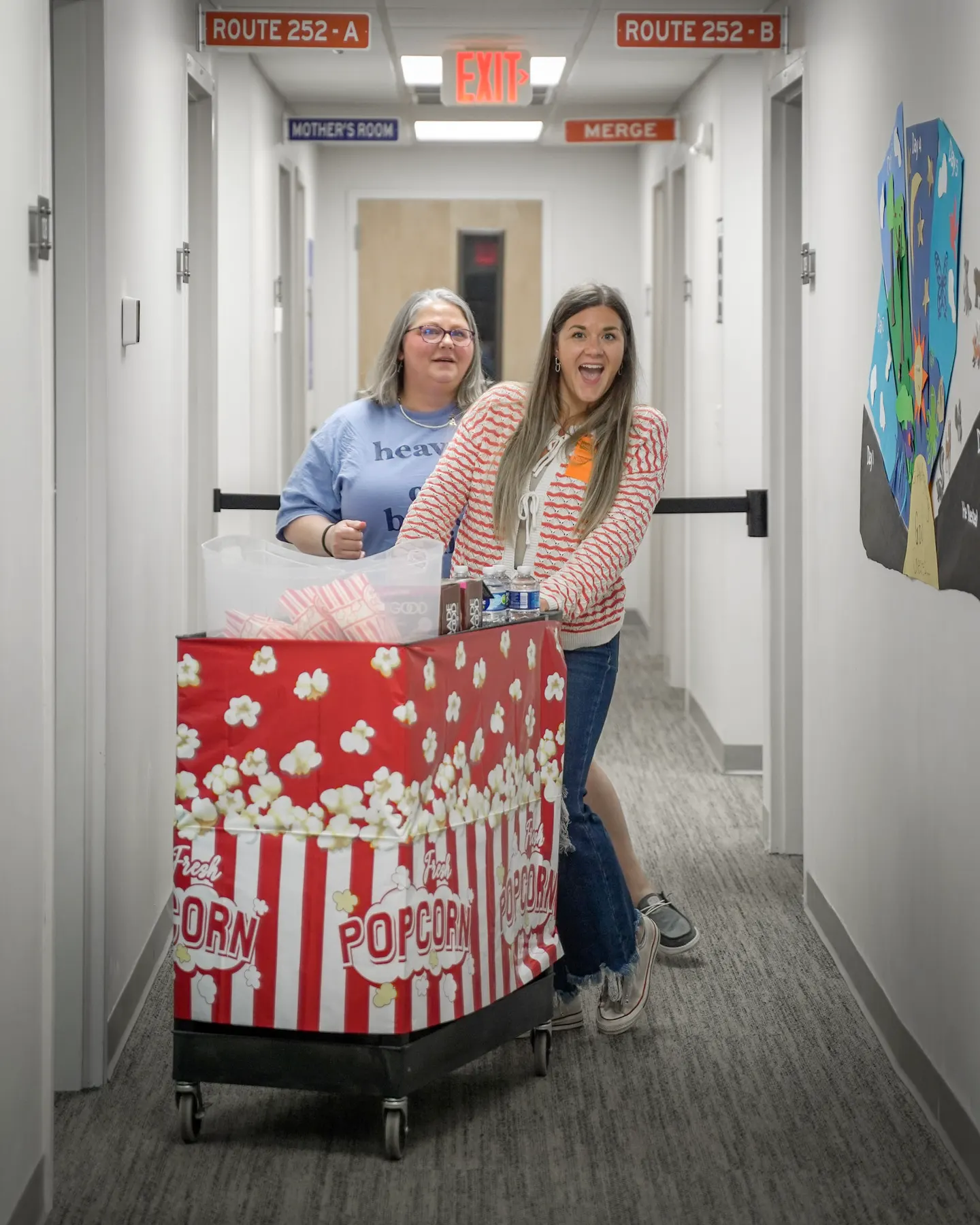 Two women pushing the popcorn cart