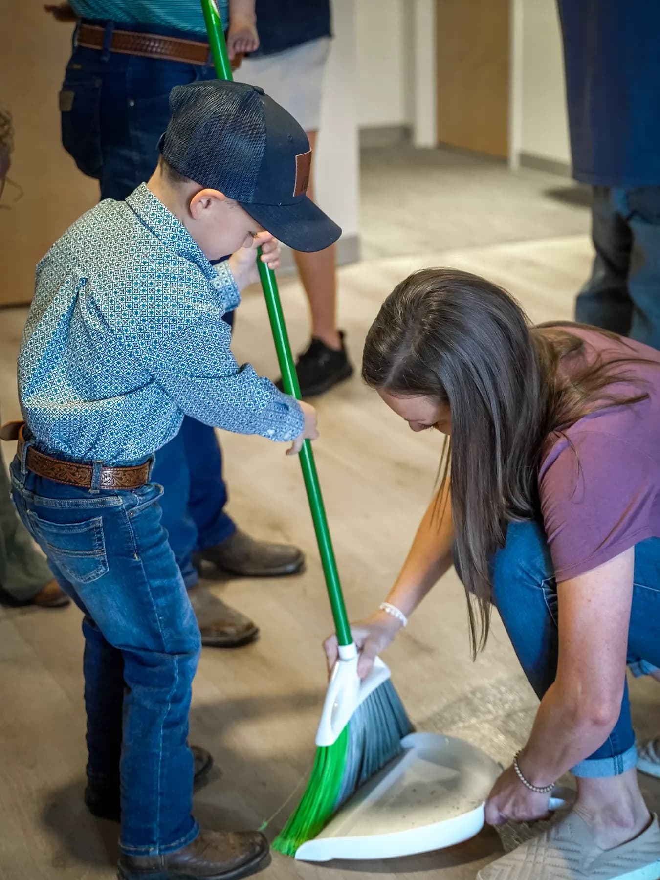 Two volunteers sweeping up together
