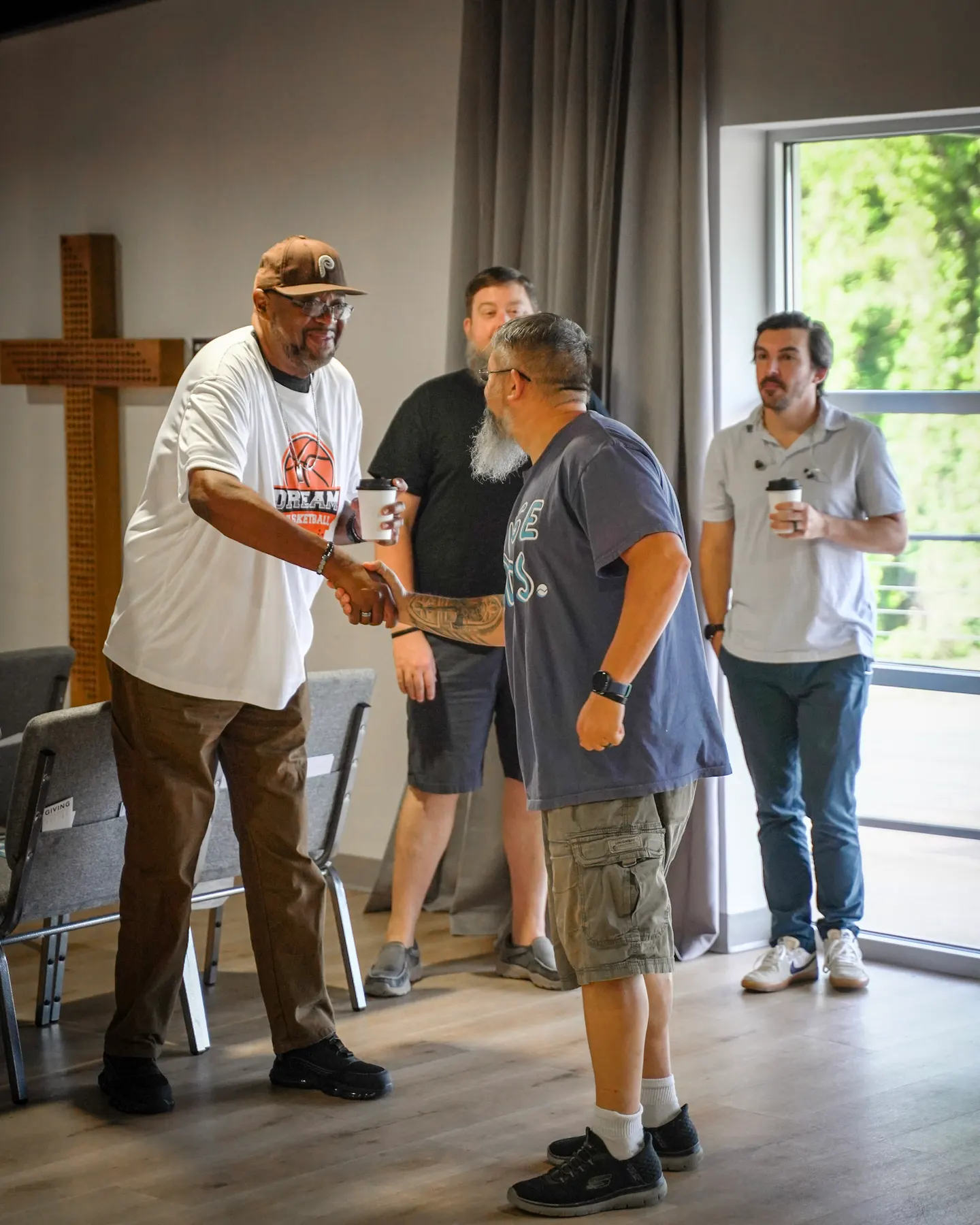 A serve team gathering, coffee still in hand