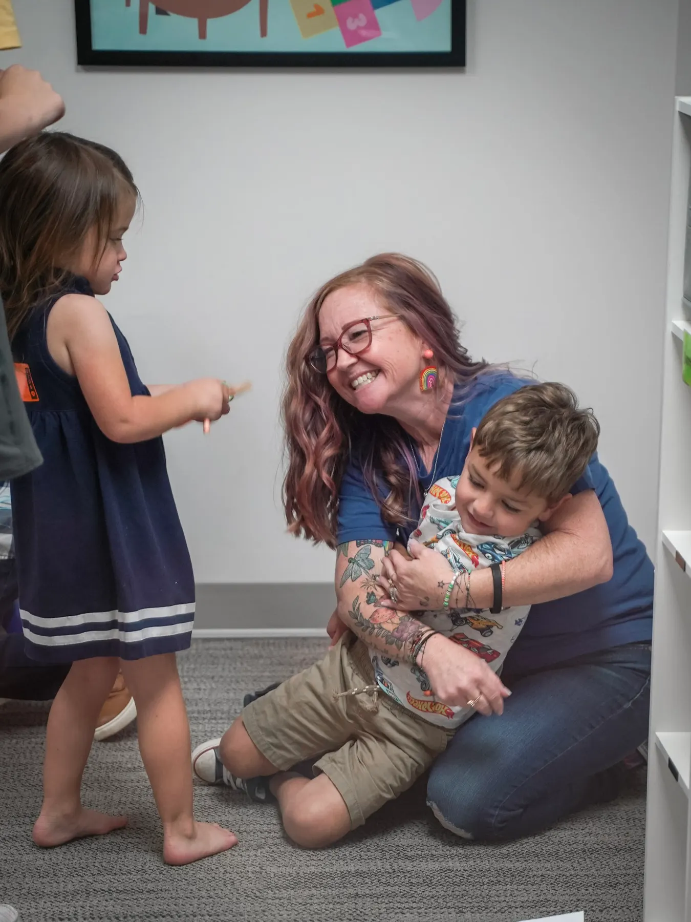 A leader on the floor with two children