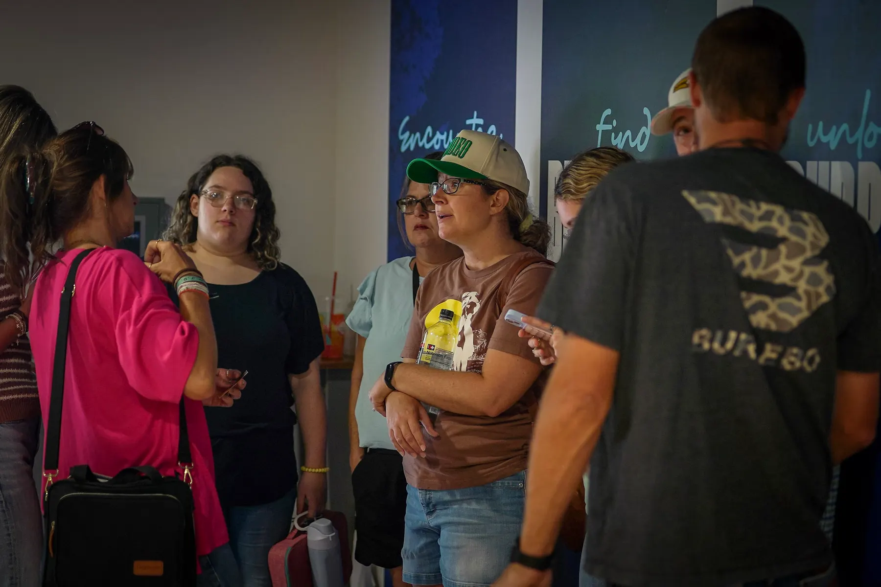 People talking in the foyer under the pathway banners