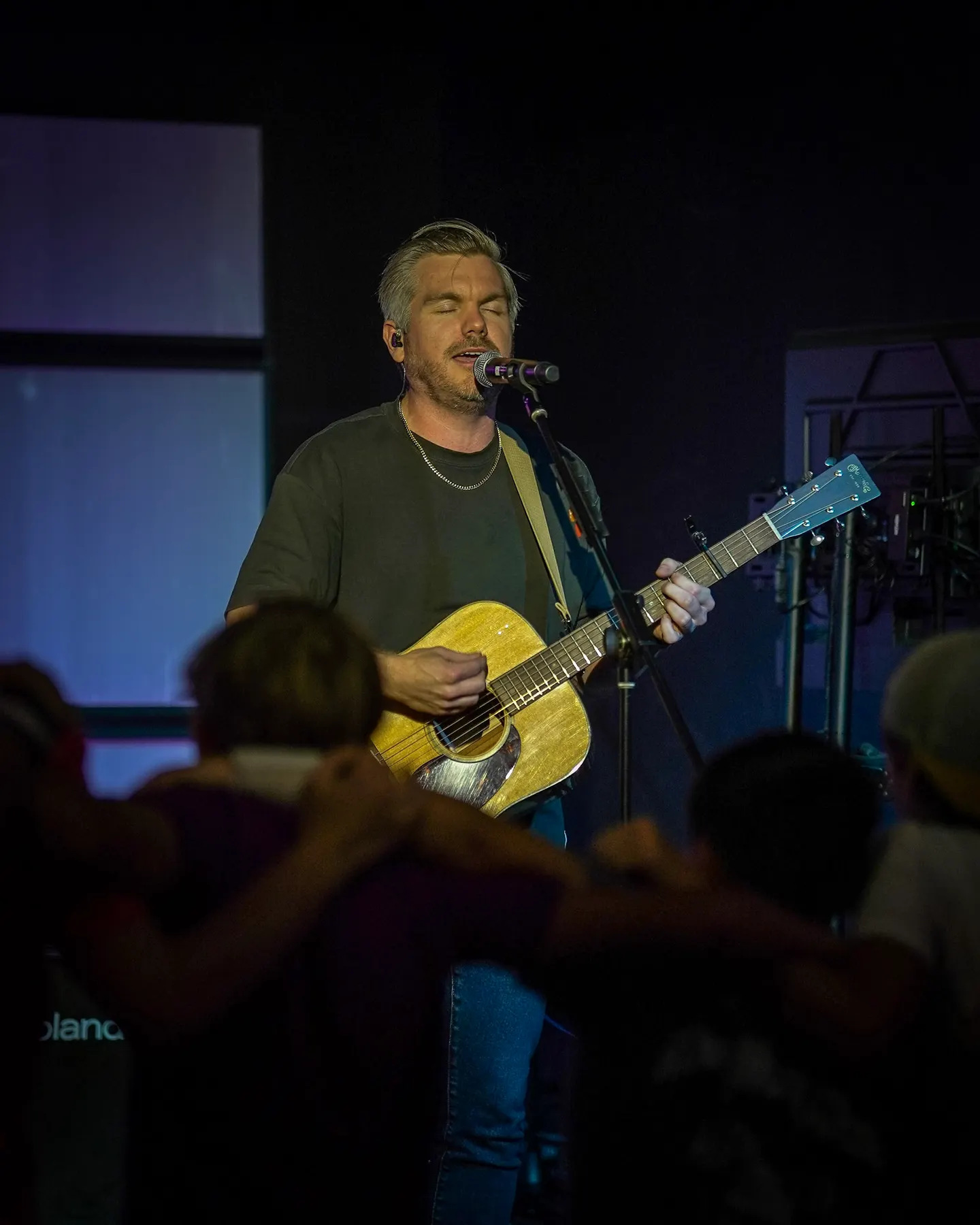 A leader playing guitar for students